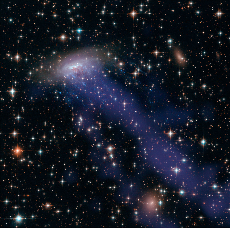 Illustration for article titled Haunting new Hubble image shows a galaxy being ripped to shreds